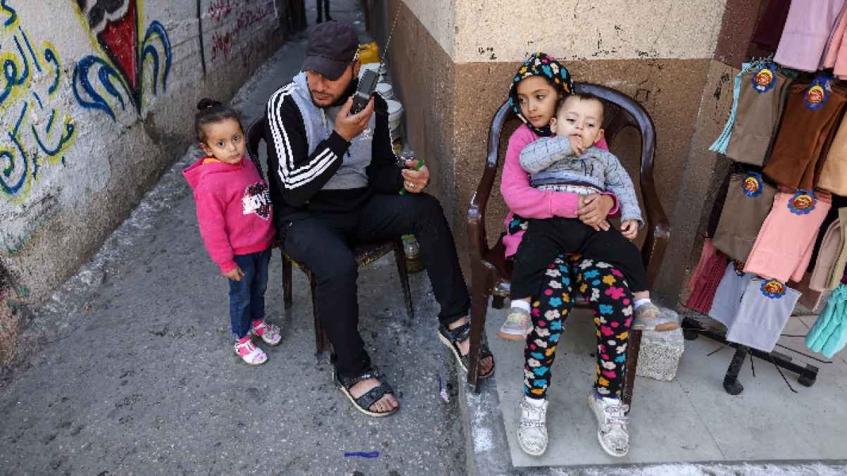 فلسطيني مع أطفاله في أحد شوارع القطاع .. فما قصته؟